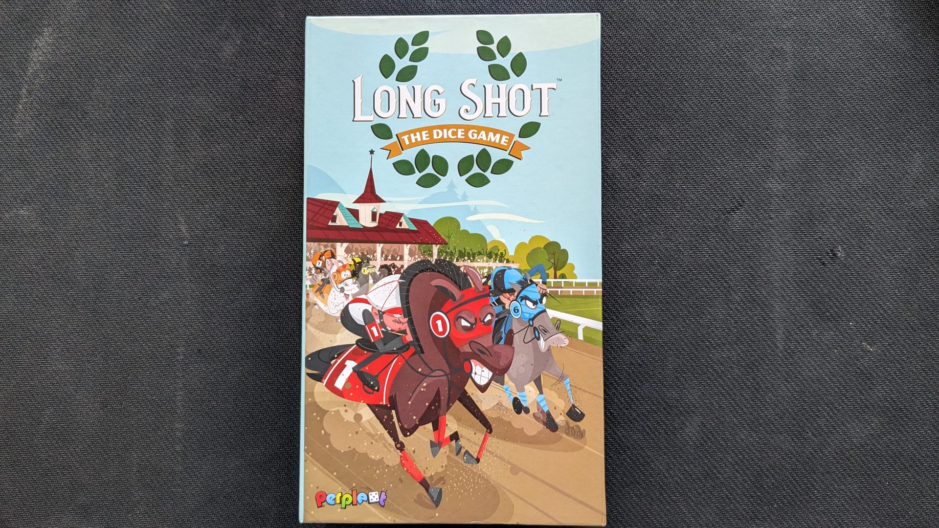 Box art for Long Shot: The Dice Game. A red horse at the front of the pack snorts as the blue horse comes up on the inside and the orange horse pursues.